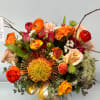  The Sunset Glow Arrangement 
Stacked high with the striking beauty of