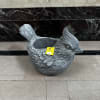A cardinal shaped stone planter.

Planter can be filled with a plant, artificial