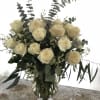 A grand arrangement of eighteen premium roses arranged with subtle accents and