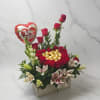 Romantic flower arrangement with fresh red roses, soft pink lilies, and lush