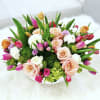 Roses, Ranunculus, Tulips and Hydrangeas arranged in white ceramic bowl. 