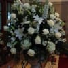 An all white sympathy spray, including Casa Blanca lilies, roses, hydrangea, stock