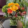 This marvelous arrangement of pinks, yellows, oranges and greens is sure to