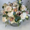 A beautiful array of hydrangeas, roses, Cymbidium orchids, with textures of sliver
