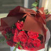 A stunning bouquet of rich red roses wrapped in paper for a