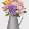 A watering can pail arranged with artificial spring silk flowers. Wonderful gift