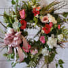 A beautiful spring wreath filled with shades of pink and white silk