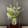 Invoke calmness with this simple but stunning bud vase of tulips, eucalyptus