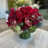 This arrangement features gorgeous burgundy Roses set in vintage green Hydrangea, with