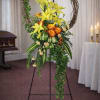 Funeral wreath with white lilies, roses, and greenery. A symbol of love