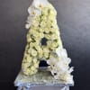 White rose and orchid floral arrangement shaped like the letter A
