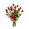 12 long stem red roses arranged in a glass vase with assorted