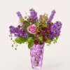 Beautiful purple flowers of many types come together in this gardeny arrangement