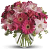 Sweet Gerbera, spray rose, and more in a rounded clear glass globe