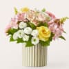 A charming blend of soft romance and fresh elegance, this arrangement features