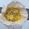 Bouquet of yellow roses wrapped in cream paper