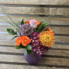 A sweet purple Posey vase filled with designers choice of purple and