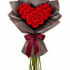 Heart-shaped bouquet of red roses wrapped in dark paper with a burgundy ribbon