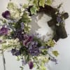 A permanent wreath with lavender and purple faux blooms