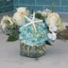 A serene mix of creamy white roses and blue hydrangea with delicate