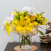 Yellow lilies and white daisies.  A clean and warm arrangement for