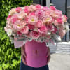 This vibrant floral arrangement is a lush combination of soft pink roses