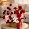 This luxurious red and blush flower arrangement is designed in a handwoven