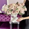 The "Elsa" flower arrangement features elegant white calla lilies, orchids, and roses