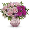 Pink roses and carnations arranged in a pink textured vase