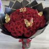 Bouquet of red roses with gold butterfly accents in black wrap