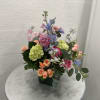 This arrangement fills the senses with thoughts of a springtime garden.