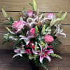 A mix of star gazer lilies, roses, hydrangeas, and snap dragons for