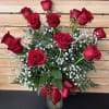 One dozen red roses arranged in a vase with baby's breath &amp;