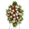 Standing spray arrangement with red roses and white flowers accented with soft