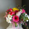 This beautiful flower arrangement of fresh mixed seasonal blooms is made by