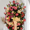 Mix pink oval standing spray with a variety of elegant flowers