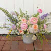 Pastel mixed flower arrangement in a white vase