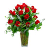 Red roses arranged in a clear glass vase