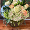 A light and simple assortment featuring antique hydrangea, ranunculus, and roses.
