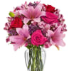 This delightful bouquet of Asiatic lilies, waxflower, alstroemeria and roses makes a