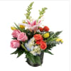 features orange roses, pink roses,  lily, snapdragons , tulips and blue