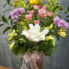 A charming mix of soft pink roses, delicate lavender buttons, sunny yellow