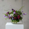 Deep purples sing in this design with textures of focal flowers like