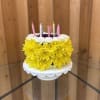 Yellow and white flower cake with striped candles on top