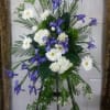 Standing floral spray with white daisies, hydrangeas, and purple irises