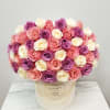 Round bouquet of pink, purple, and white roses in a cream hat box