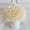 Bouquet of cream roses in a white hatbox