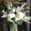 Tall vase filled with white and cream colored blossoms.  It depends