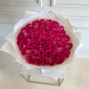 Bouquet of hot pink roses wrapped in white paper