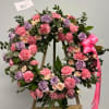 A tender expression of love and remembrance, this wreath features a soft